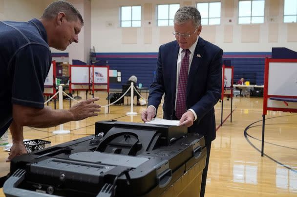 PHOTO: Chris Doughty, right, casts his ballot, as election worker Todd Duffy, left, looks on, Sept. 6, 2022, in Wrentham, Mass., in the state's primary election. (Steven Senne/AP)