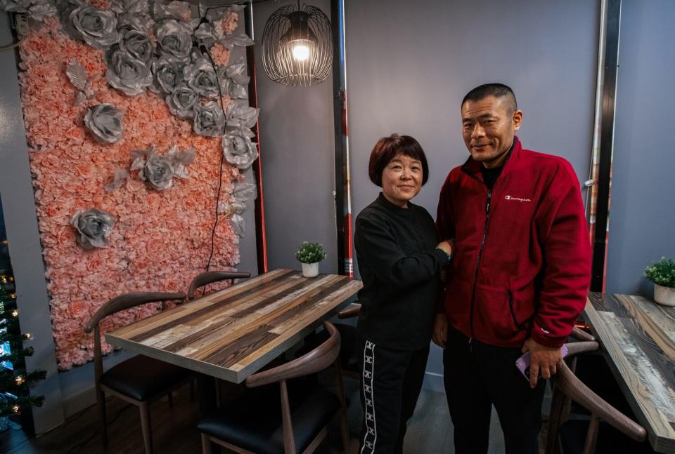 A woman, left, and a man in a restaurant