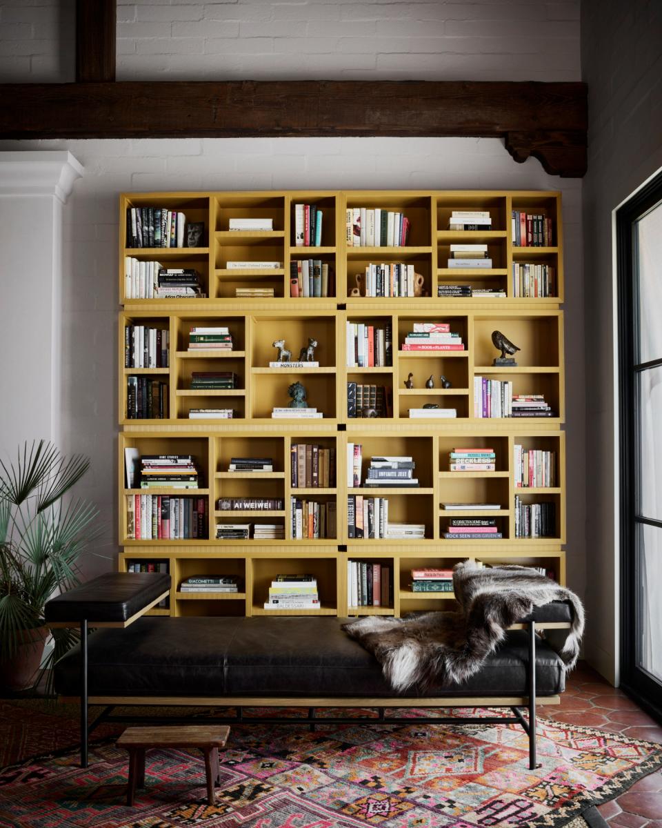 A custom bookcase anchors one end of the living room.