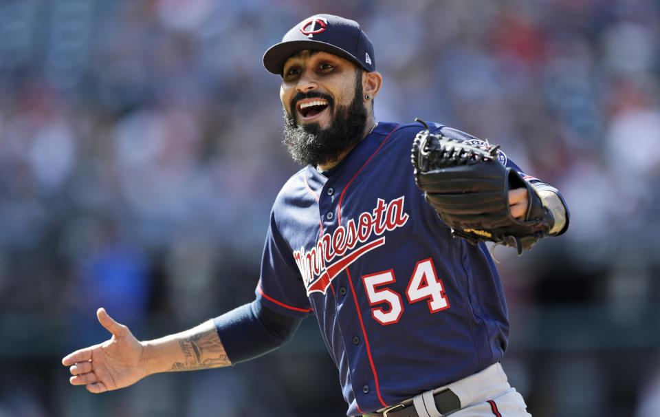 Minnesota Twins relief pitcher Sergio Romo walks back to the dugout with a smile in the eighth inning in the first baseball game of a baseball doubleheader against the Cleveland Indians, Saturday, Sept. 14, 2019, in Cleveland. The Twins won 2-0. (AP Photo/Tony Dejak)