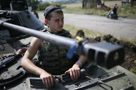 A Ukrainian soldier looks out from an armored vehicle at a position about 60 km from the eastern Ukrainian city of Donetsk July 10, 2014. REUTERS/Gleb Garanich