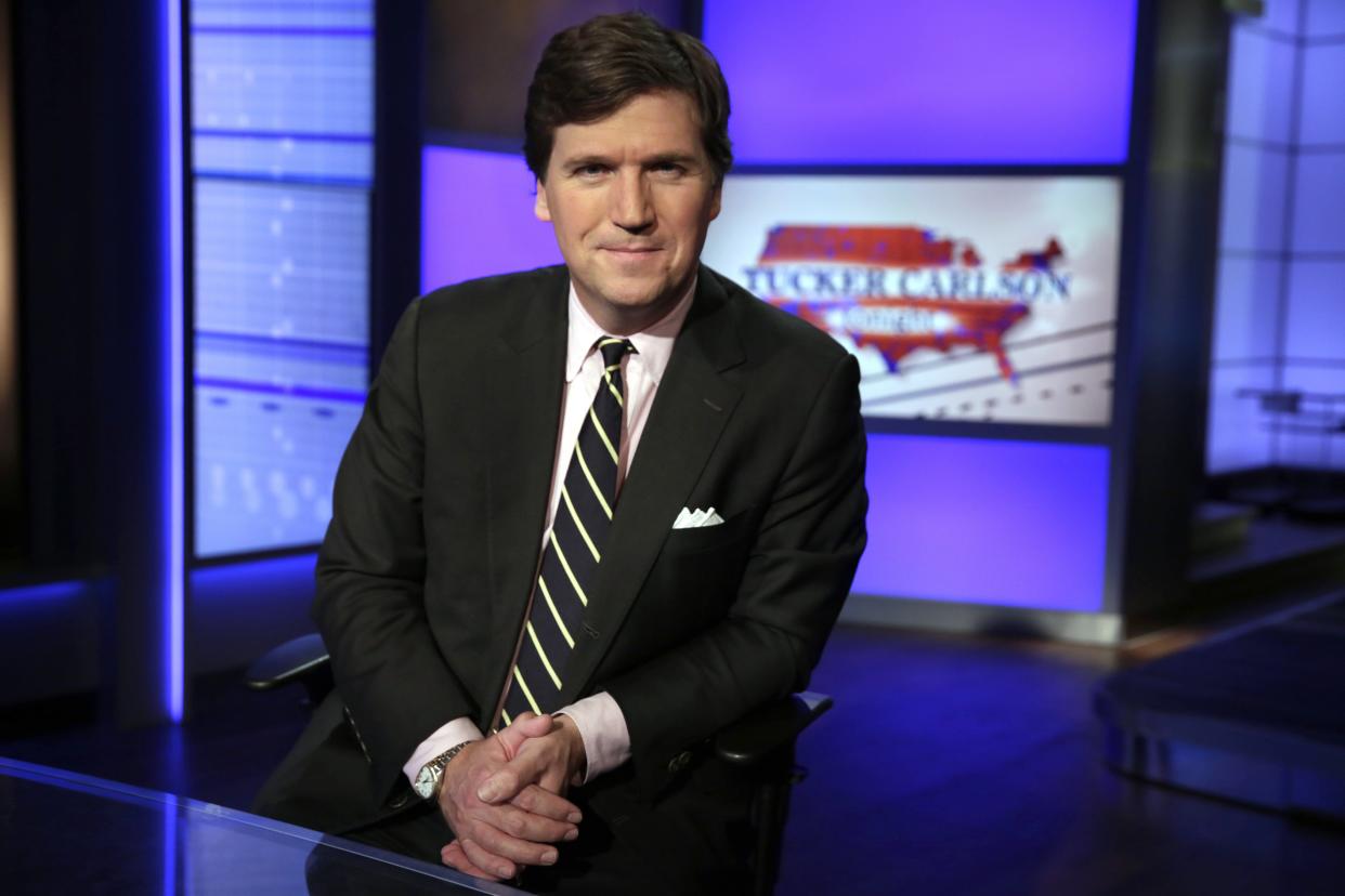 FILE - In this March 2, 20217, file photo, Tucker Carlson, host of "Tucker Carlson Tonight," poses for photos in a Fox News Channel studio in New York.