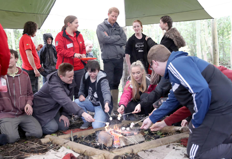 Harry stood patiently by while the kids roasted &rsquo;mallows, his arms crossed. (Photo: PA Wire/PA Images)