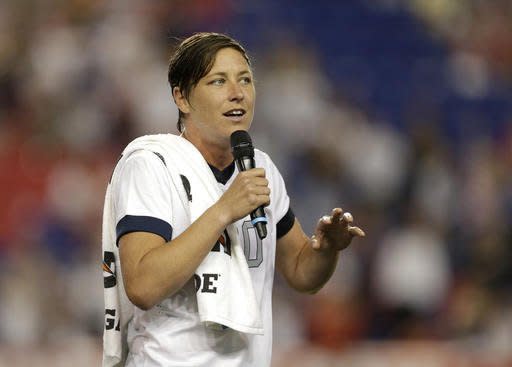 FILE - In this June 20, 2013 file photo, United States' Abby Wambach talks to spectators after an international friendly soccer match in Harrison, N.J. Retired U.S. national team star Abby Wambach is joining ESPN as an analyst and a contributor. Wambach, who is the leading international goal scorer of all time, will cover the European Championships in France and the Rio Olympics in August. But her role will not be limited to soccer: she’ll work across multiple platforms including ESPN Films and shows including “Outside the Lines,” the network said. (AP Photo/Julio Cortez, File)