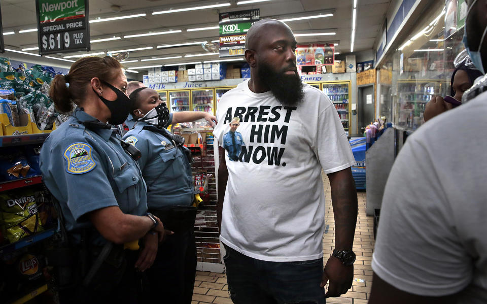 Michael Brown, Sr. arrives at the Ferguson Market as Ferguson police officers talk with protesters who tried to shut down the store on Thursday, July 30, 2020 in Ferguson, Mo. St. Louis County’s prosecutor announced Thursday that he will not charge the former police officer who fatally shot Michael Brown in Ferguson. (Robert Cohen/St. Louis Post-Dispatch via AP)