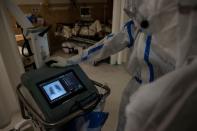 Medical workers treat patients infected with the coronavirus disease (COVID-19) at a hospital in New Delhi