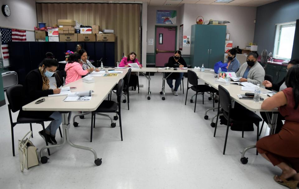 Students complete workbook exercises at the Alisal Family Resource Center's Plaza Comunitaria class for Spanish speakers in Salinas, Calif.