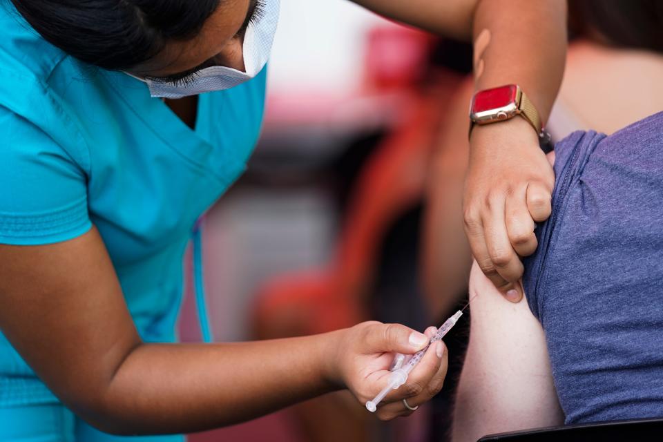 A woman administers the monkeypox vaccine at a walk-in clinic at the North Jersey Community Research Initiative in Newark, N.J., Tuesday, Aug. 16, 2022.