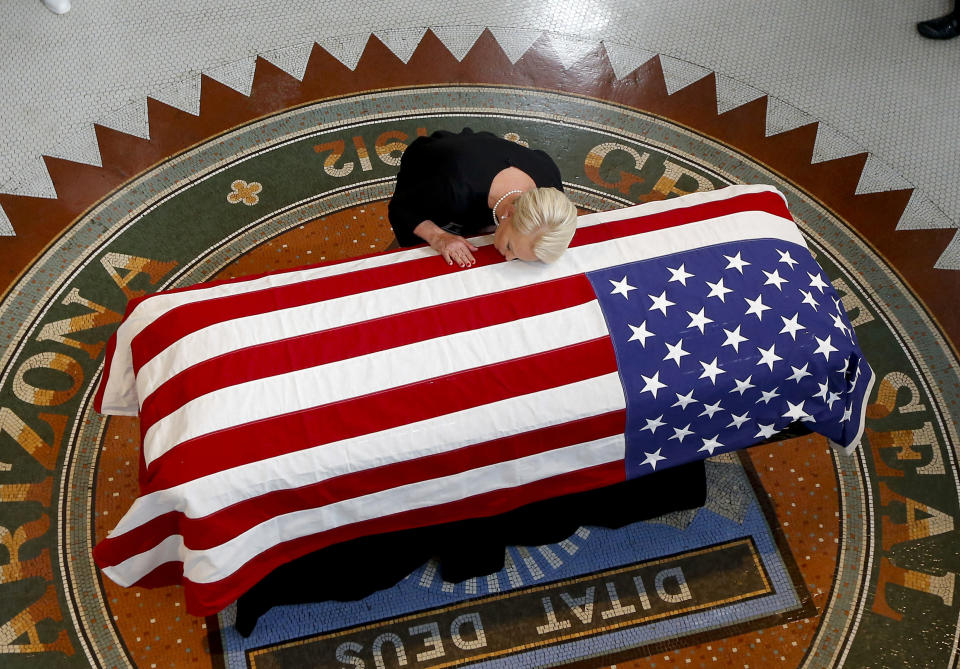 <p>Cindy McCain, wife of, Sen. John McCain, R-Ariz. lays her head on casket during a memorial service at the Arizona Capitol on Wednesday, Aug. 29, 2018, in Phoenix. (Photo: Ross D. Franklin, Pool/AP) </p>