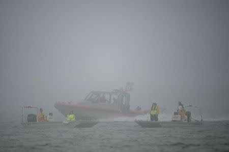 Rescue crews search waters near Navarre Bridge, east of Pensacola, Florida March 11, 2015. REUTERS/Michael Spooneybarger