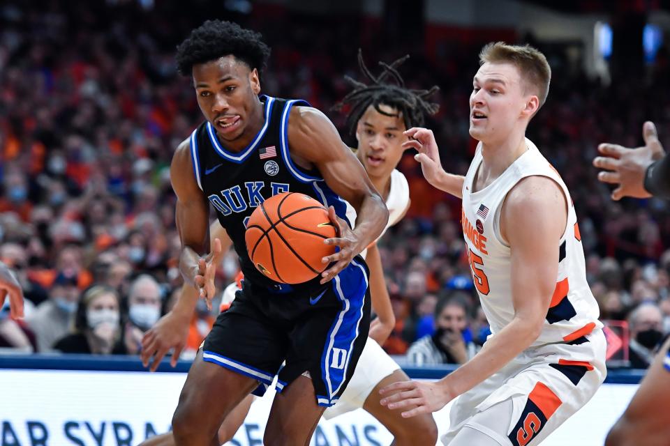 Duke guard Jeremy Roach, left, drives past Syracuse guard Buddy Boeheim during the first half of their game in Syracuse, N.Y., Saturday, Feb. 26, 2022.