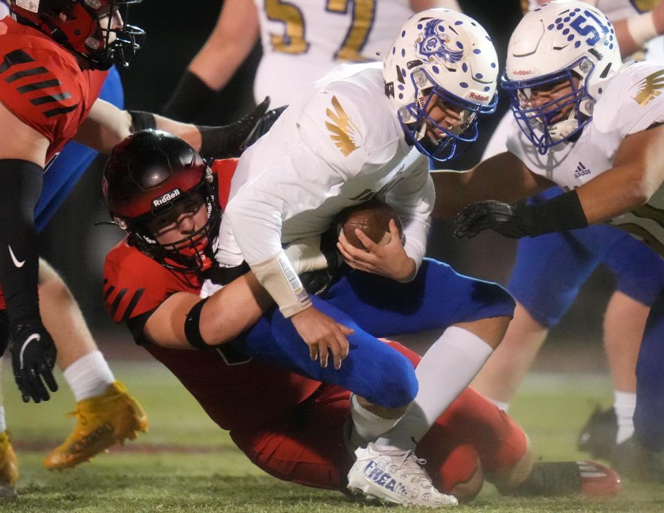 Liberty Lions linebacker Rune Tepolt (4) tackles Sandra Day O’Connor Eagles quarterback Cooper King (2) during their open division playoff game on Friday, Nov. 25, 2022. 