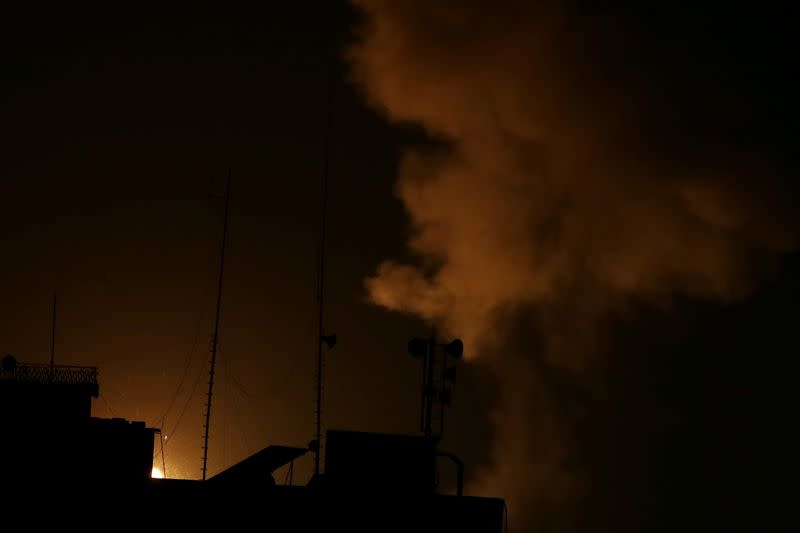 Smoke and flame are seen following an Israeli air strike in Gaza Strip