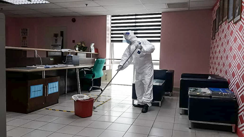 A worker sanitises the Seberang Perai Municipal Council building after one of its staff tested positive for Covid 19. — Picture courtesy of MBSP