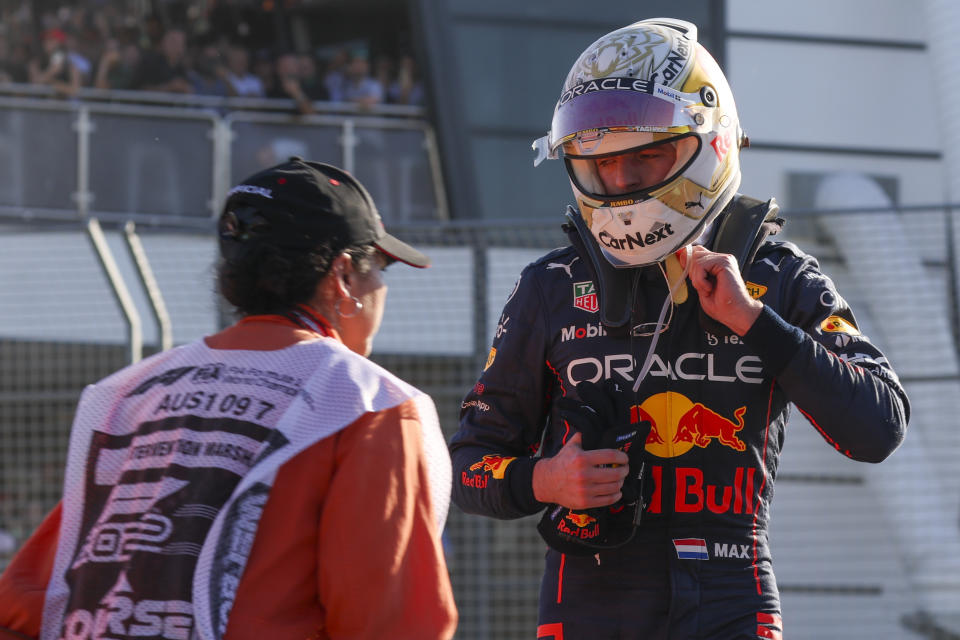 Red Bull driver Max Verstappen of the Netherlands looks at his car after he withdrew from the Australian Formula One Grand Prix in Melbourne, Australia, Sunday, April 10, 2022. (AP Photo/Asanka Brendon Ratnayake)