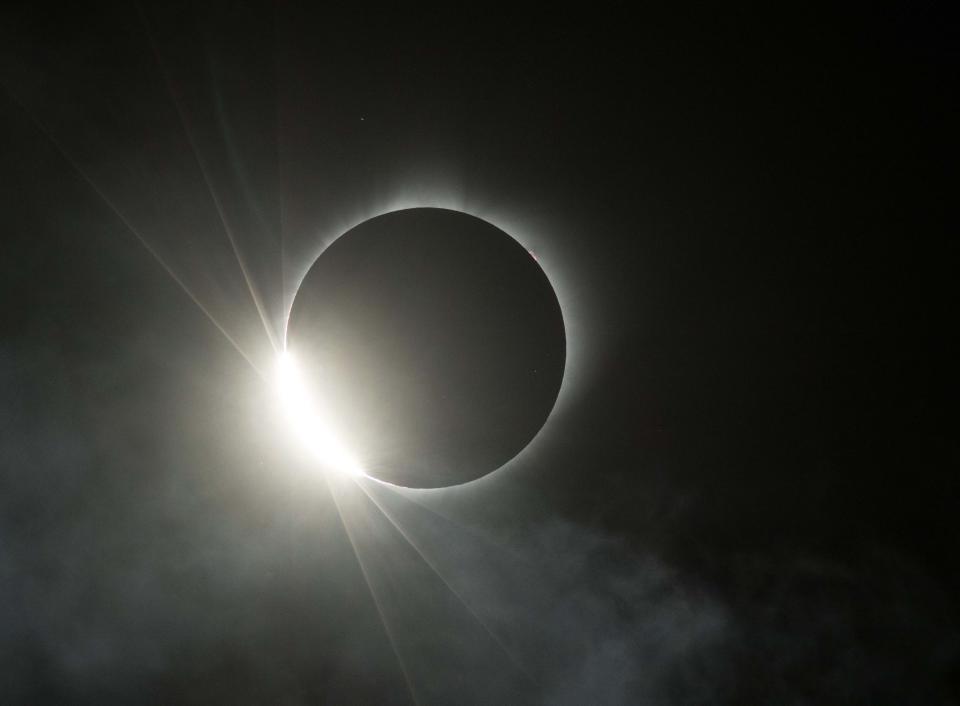 The moon eclipses the sun for a total solar eclipse over Carhenge in Alliance, Neb.  