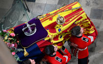 <p>LONDON, ENGLAND - SEPTEMBER 19: The coffin of Queen Elizabeth II with the Imperial State Crown resting on top is carried by the Bearer Party into Westminster Abbey during the State Funeral of Queen Elizabeth II on September 19, 2022 in London, England. Elizabeth Alexandra Mary Windsor was born in Bruton Street, Mayfair, London on 21 April 1926. She married Prince Philip in 1947 and ascended the throne of the United Kingdom and Commonwealth on 6 February 1952 after the death of her Father, King George VI. Queen Elizabeth II died at Balmoral Castle in Scotland on September 8, 2022, and is succeeded by her eldest son, King Charles III. (Photo by Gareth Cattermole/Getty Images)</p> 