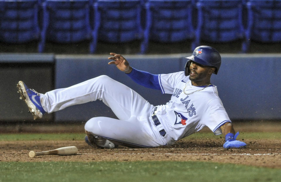 Toronto Blue Jays' Josh Palacios scores on Joe Panik's single off Los Angeles Angels reliever Aaron Sloggers during the eighth inning of a baseball game Saturday, April 10, 2021, in Dunedin, Fla. (AP Photo/Steve Nesius)