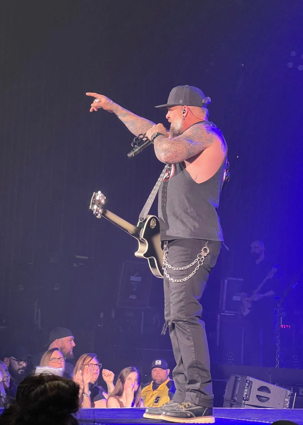 Country music artist Brantley Gilbert gestures toward the crowd at Thursday night's concert at the Canton Memorial Civic Center.