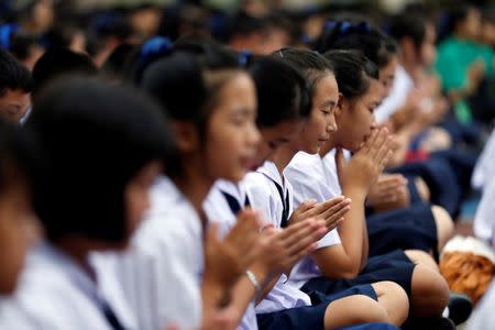 Students pray in Mae Sai Prasitsart school as an ongoing search for members of an under-16 soccer team and their coach who went missing in a flooded cave continues, in the northern province of Chiang Rai, Thailand, July 2, 2018. REUTERS/Soe Zeya Tun