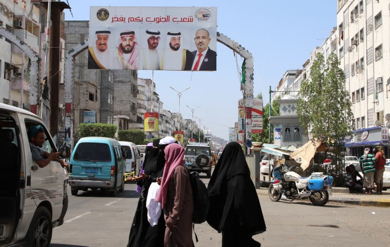 Cars drive under a billboard with poster of Saudi King Salman bin Abdul Aziz, Saudi Crown Prince Muhammad bin Salman, Abu Dhabi’s Crown Prince Mohammed bin Zayed Al Nahyan, UAE President Khalifa bin Zayed Al Nahyan and Aidarous al-Zabidi