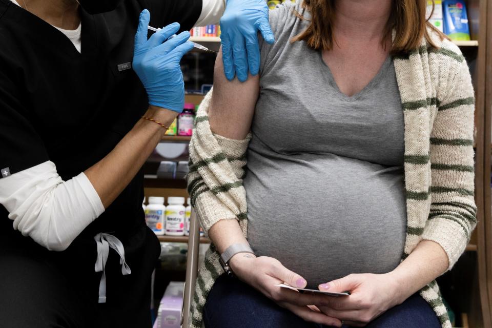 <p>A pregnant woman receives a Covid-19 vaccine in Pennsylvania</p> (Reuters)