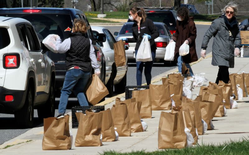 Volunteers offer free food to families who can't access school based food programs for their children during closure because of coronavirus pandemic in Maryland