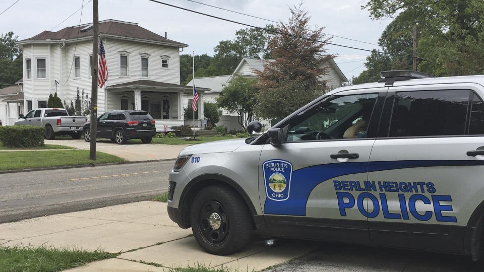 A Berlin Heights police officer sits across the road from the home of Maxton Soviak, Friday, August 27, 2021, in Berlin Heights, Ohio. Soviak, a U.S. Navy Fleet Marine Force hospital corpsman, was killed Thursday in Afghanistan. (AP Photo/John Seewer)