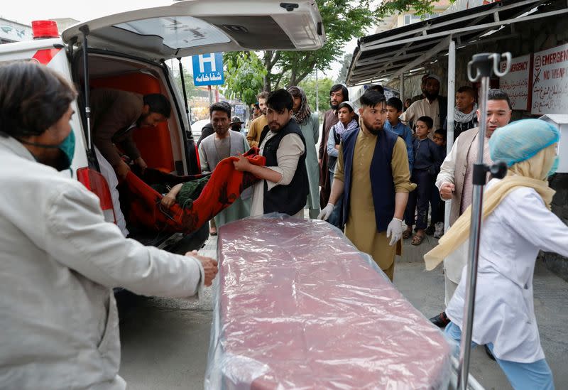 An injured person is transported to a hospital after a blast in Kabul