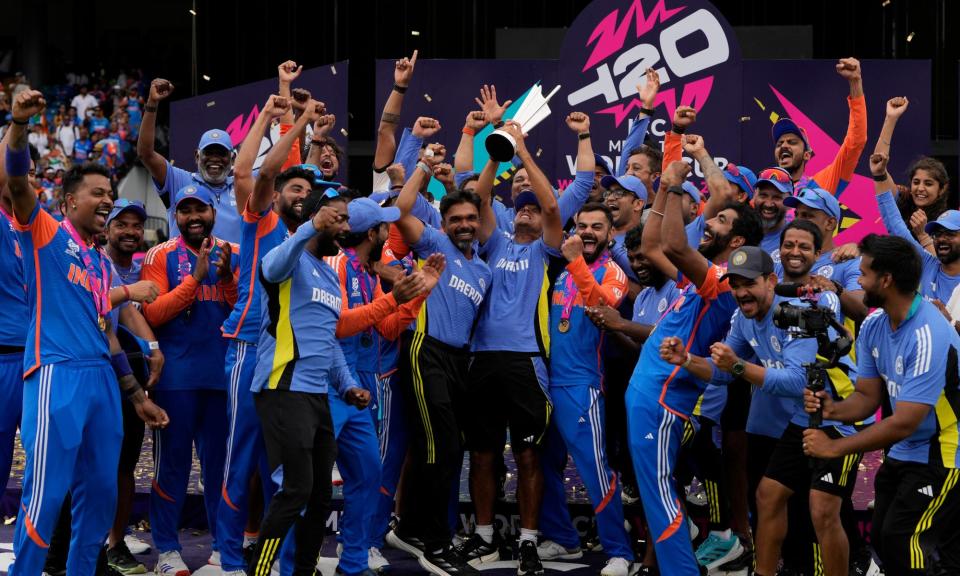 <span>India's head coach Rahul Dravid (centre) and his players celebrate with the winners trophy after their victory against South Africa.</span><span>Photograph: Ricardo Mazalán/AP</span>