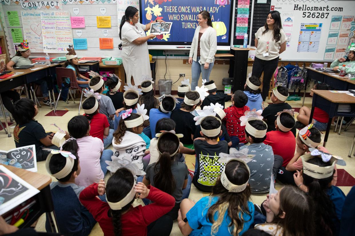 Third grade students listen to teachers, from left, Jessica Ledesma, Miranda Choma and Angelina Rivera, read a Thanksgiving book to students at Sam Houston Elementary on Thursday, Nov. 16, 2023, in Corpus Christi, Texas.