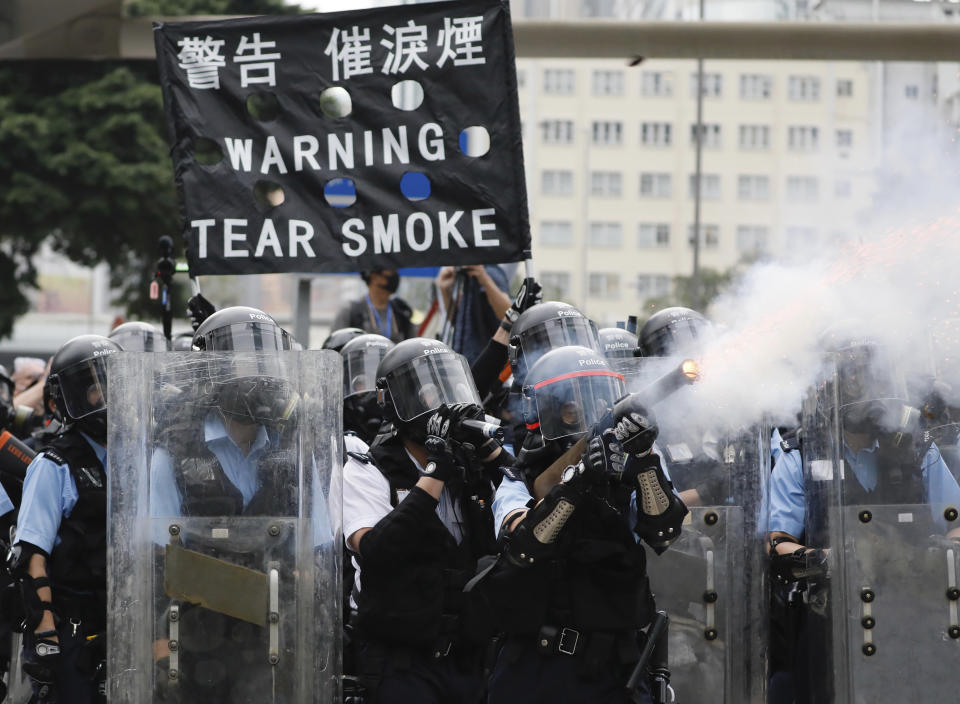 FILE - In this file photo taken Wednesday, June 12, 2019, police fire tear gas towards protesters outside the Legislative Council in Hong Kong. Hong Kong police have resorted to harsher-than-usual tactics to suppress protesters this week in the city’s most violent turmoil in decades. Police fired rubber bullets and beanbag rounds at the crowds, weapons that have not been widely used in recent history. (AP Photo/Vincent Yu, File)