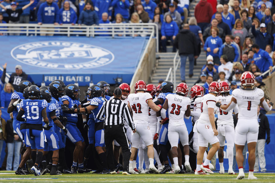 Kentucky and Louisville players are separated from a scrum during the first half of an NCAA college football game in Lexington, Ky., Saturday, Nov. 26, 2022. (AP Photo/Michael Clubb)