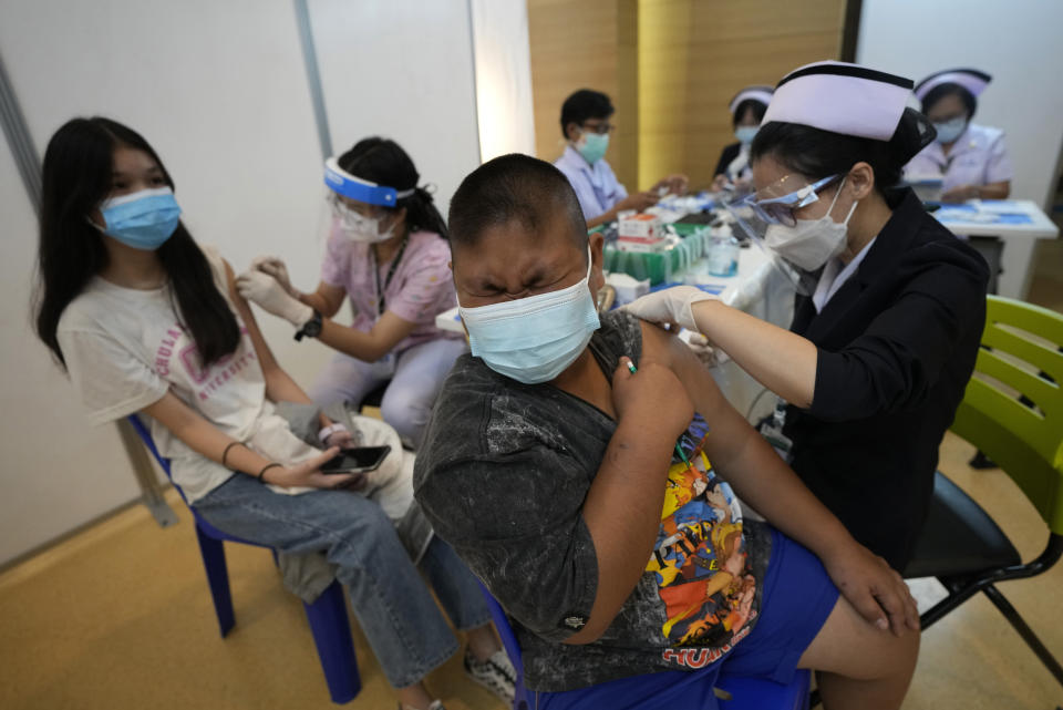 Health workers administer doses of the Pfizer-BioNTech COVID-19 vaccine at a hospital in Bangkok, Thailand, Tuesday, Sept. 21, 2021. Bangkok Metropolitan Administration inoculated 12-18 year old students Tuesday as part of its attempt to reopen on-site schools. (AP Photo/Sakchai Lalit)