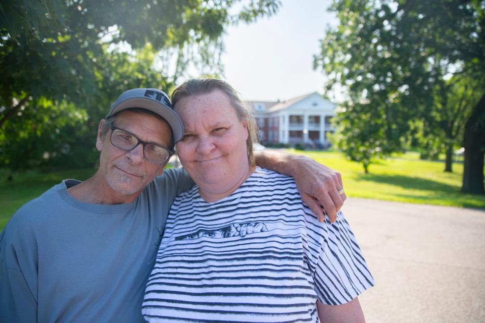 Melissa McDonald and Craig Coburn-McDonald pose for a portrait in front of Portage Manor, on Monday July 31, 2023.