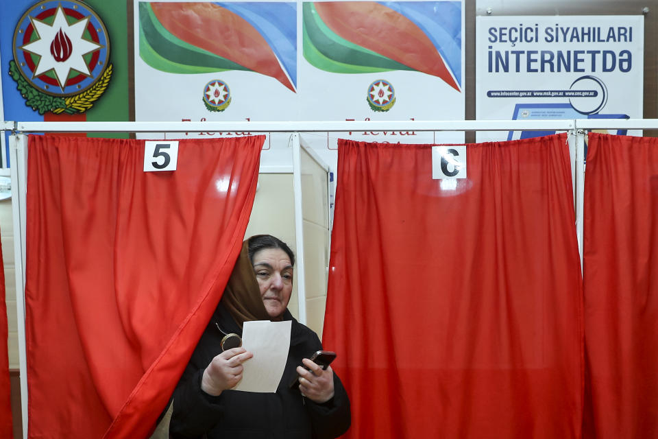 A woman leaves a voting booth at a polling station during presidential election in Baku, Azerbaijan, Wednesday, Feb. 7, 2024. Azerbaijanis are voting Wednesday in an election almost certain to see incumbent President Ilhan Aliyev chosen to serve another seven-year term. (AP Photo/Aziz Karimov)