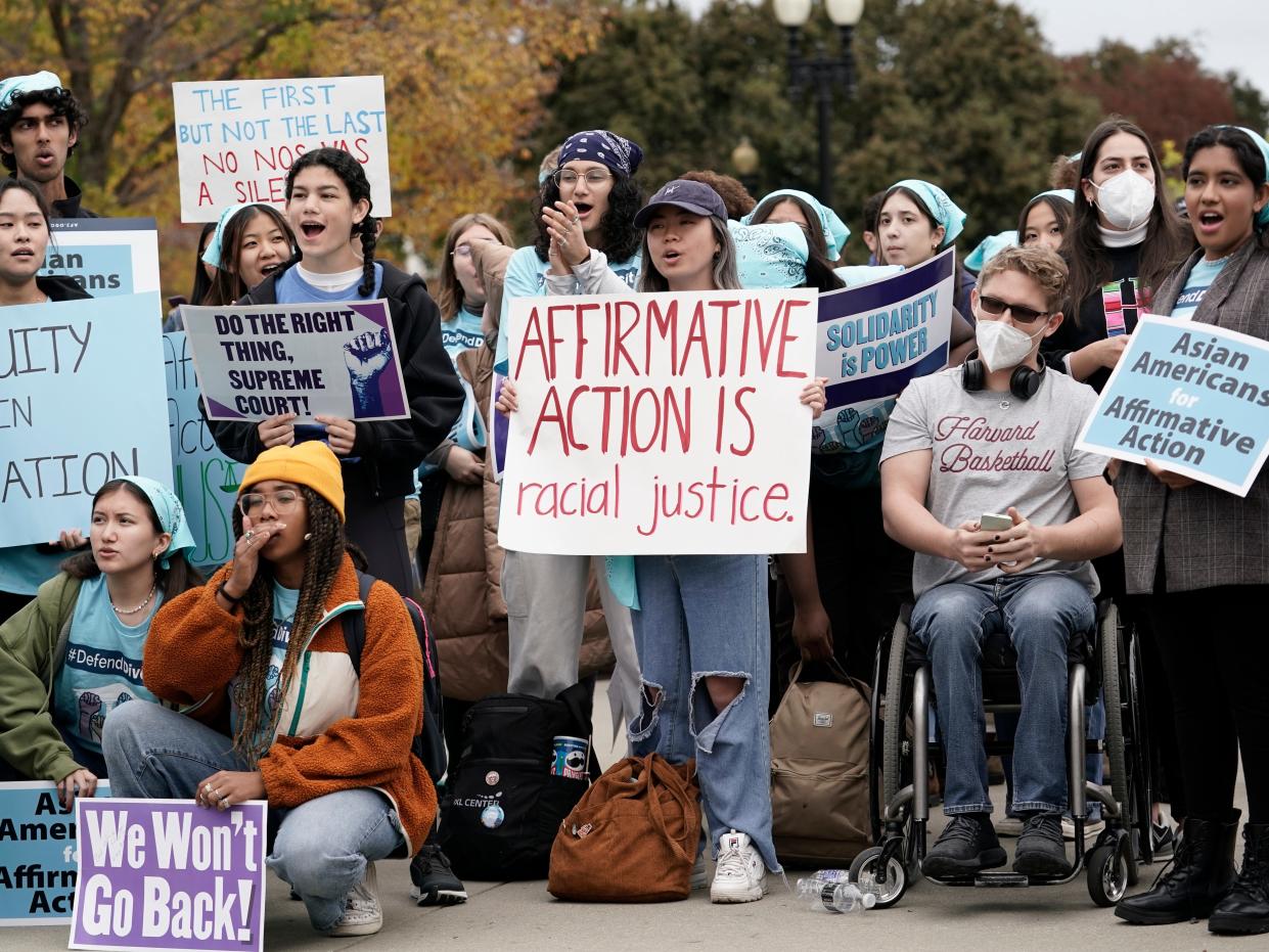 People rally outside the Supreme Court as the court begins to hear oral arguments in two cases that could decide the future of affirmative action in college admissions, Monday, Oct. 31, 2022.