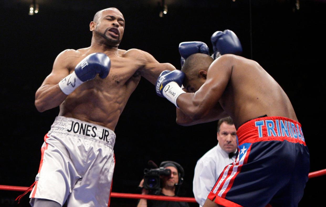 Roy Jones Jr., left, lands a punch against Felix Trinidad during light heavyweight boxing bout Jan. 19, 2008, at Madison Square Garden in New York.