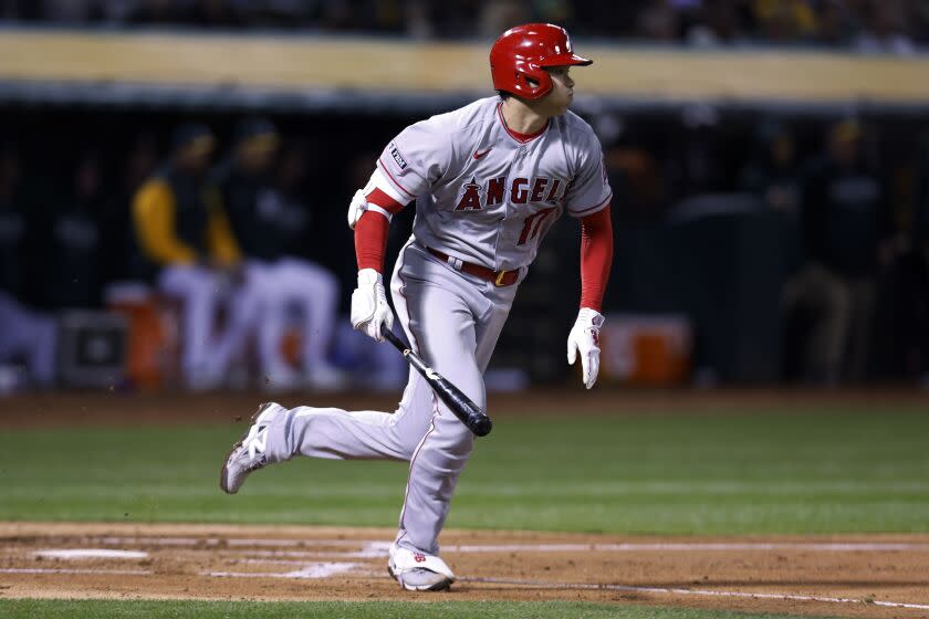 Los Angeles Angels' Shohei Ohtani runs to first after hitting a single against the Oakland Athletics.