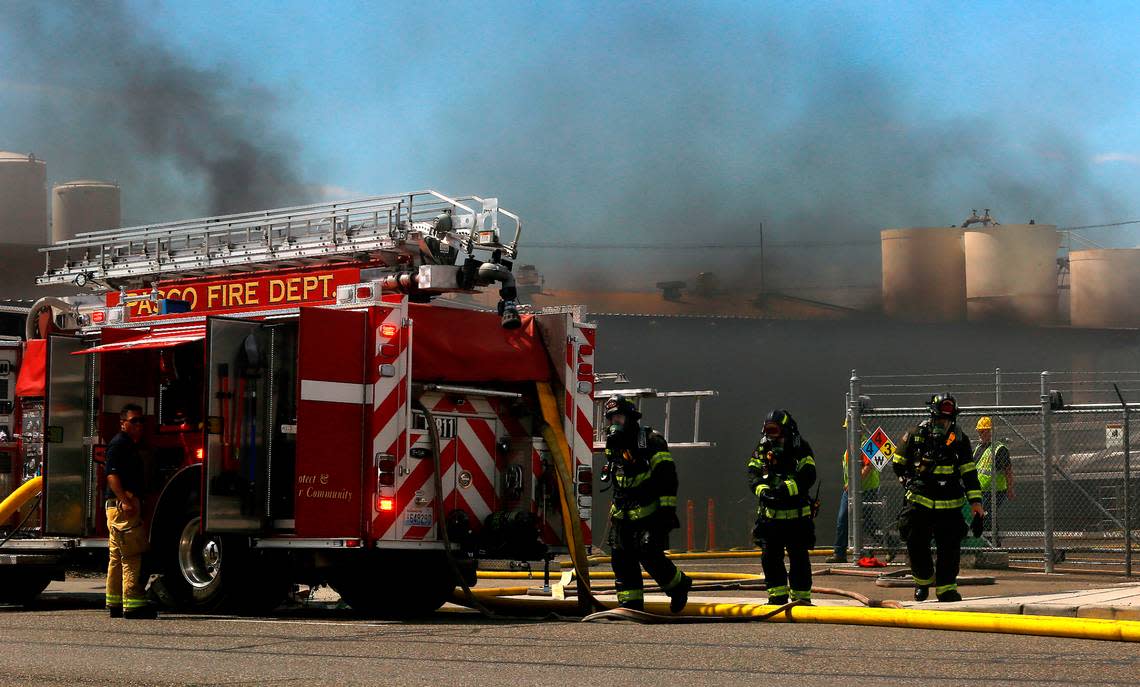 Firefighters from around the Tri-Cities area methodically work Tuesday to extinguish a fire in the acetylene manufacturing room at the Oxarc Inc. business on the corner of A Street and Oregon Avenue in Pasco. No injuries were reported. Bob Brawdy/bbrawdy@tricityherald.com