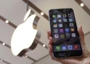 A woman holds up the iPhone 6 Plus at the Apple Store at Tokyo's Omotesando shopping district September 19, 2014. REUTERS/Yuya Shino