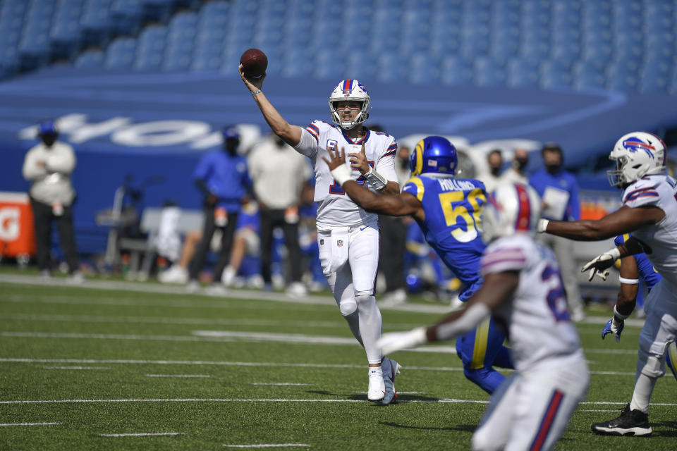 Buffalo Bills quarterback Josh Allen, left, throws a pass to running back Devin Singletary during the first half of an NFL football game Sunday, Sept. 27, 2020, in Orchard Park, N.Y. (AP Photo/Adrian Kraus)