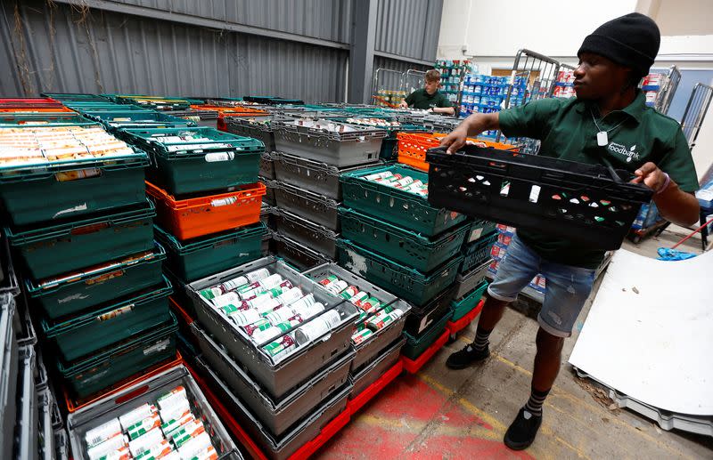 Volunteers at the charity Greenwich Foodbank, Jerald De-Great Aryee and Daniel Kennett-Brown organise stocks of food