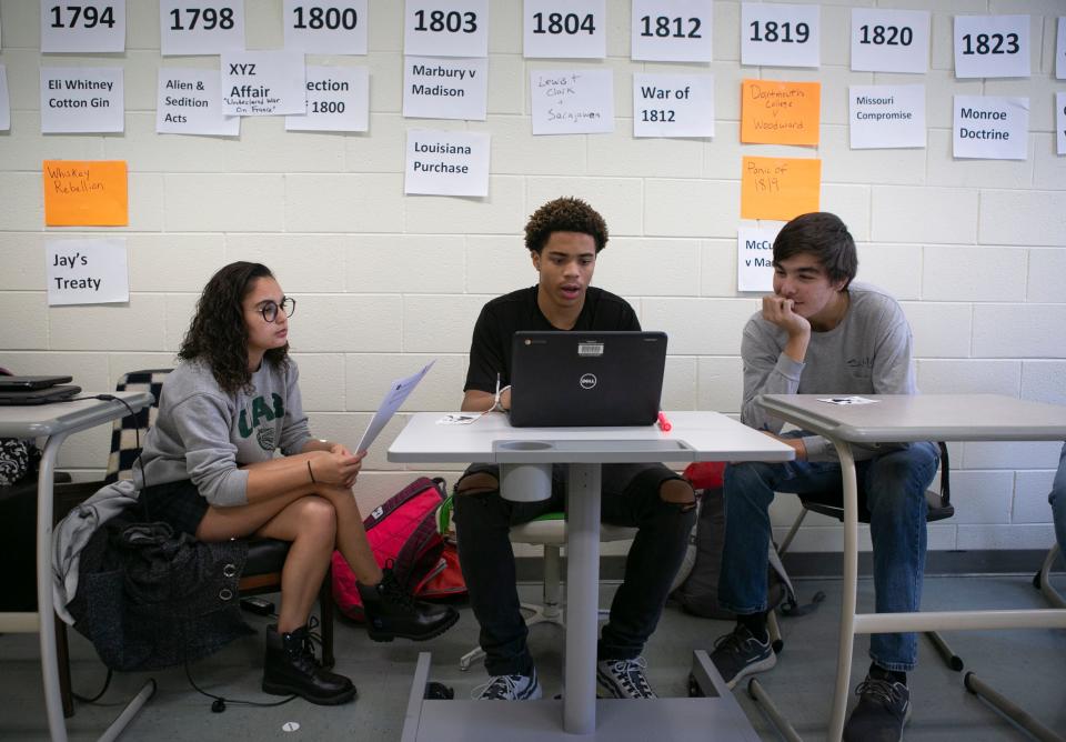 From left, Keona Barnwell, 17, Jaquan Harris, 17, and Preston Walker, 18, study impeachment Wednesday, November 20, 2019 at Powhatan High School in Powhatan, Virginia.