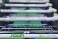 Trolleys are lined up outside an ASDA supermarket in London January 23, 2012. REUTERS/Finbarr O'Reilly