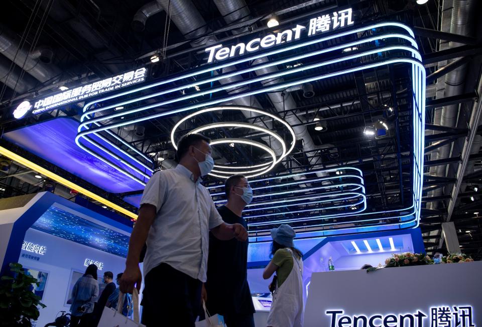 People walk past the Tencent booth at the China International Fair for Trade in Services (CIFTIS) in Beijing on September 6, 2020. (Photo by NOEL CELIS / AFP) (Photo by NOEL CELIS/AFP via Getty Images)