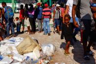 Migrants wait as they hope to obtain humanitarian visas to transit Mexican territory, in Tapachula