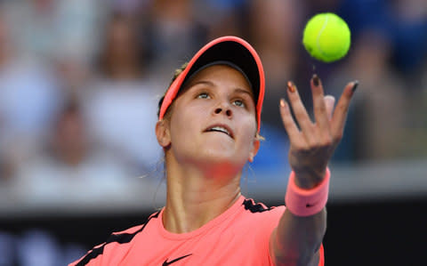 Canada's Eugenie Bouchard serves against Romania's Simona Halep during their women's singles second round match on day four of the Australian Open tennis tournament - Credit: AFP/Getty Images