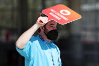 A worker holds a 'face coverings required' sign before Super Bowl LV between the Tampa Bay Buccaneers and the Kansas City Chiefs at Raymond James Stadium on February 07, 2021 in Tampa, Florida. (Photo by Patrick Smith/Getty Images)