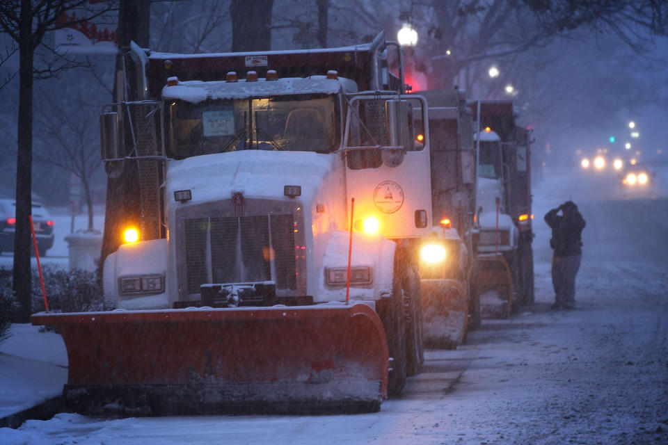 Snowplows stand by on a street January 22, 2016 in Washington, DC. A winter snowstorm is forecasted for the East Coast this weekend with prediction of up to 30 inches of snow for the DC area.